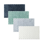 Solace Pebble Bathmat range displayed in Ebony, Eucalyptus, Grey and Cream, featuring a soft textured pebble-inspired pattern.