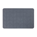 Algodon Dri Stone Bath Mat Charcoal with a geometric chevron pattern and rounded corners.