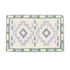 Bathmat featuring an Geometric-inspired tufted pattern in soft green, blue, and cream tones on a clean white background.
