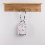 Seaside Supplies Waterproof Beach Bag 5.8L Sailor featuring a white background decorated with colourful nautical illustrations including sailboats, anchors, ship wheels and lobsters.