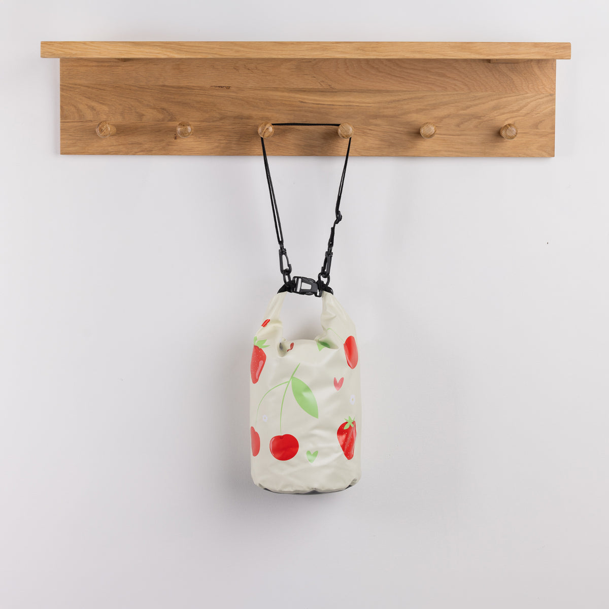 Seaside Supplies Waterproof Beach Bag 5.8L Fruit Mix Lemon featuring a cream background decorated with red cherries, strawberries, green leaves and small hearts.