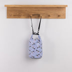 Seaside Supplies Waterproof Beach Bag 5.8L Oyster Catchers featuring a light blue background with repeating black and white oystercatcher birds, red legs and long red beaks.