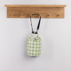 Seaside Supplies Waterproof Beach Bag 5.8L Gingham Check featuring a soft green and white gingham pattern with a roll-top buckle closure and adjustable black shoulder strap.