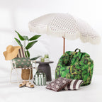 Floral print umbrella styled with a beach chair, side table, tropical bean bag, cushions and summer accessories.