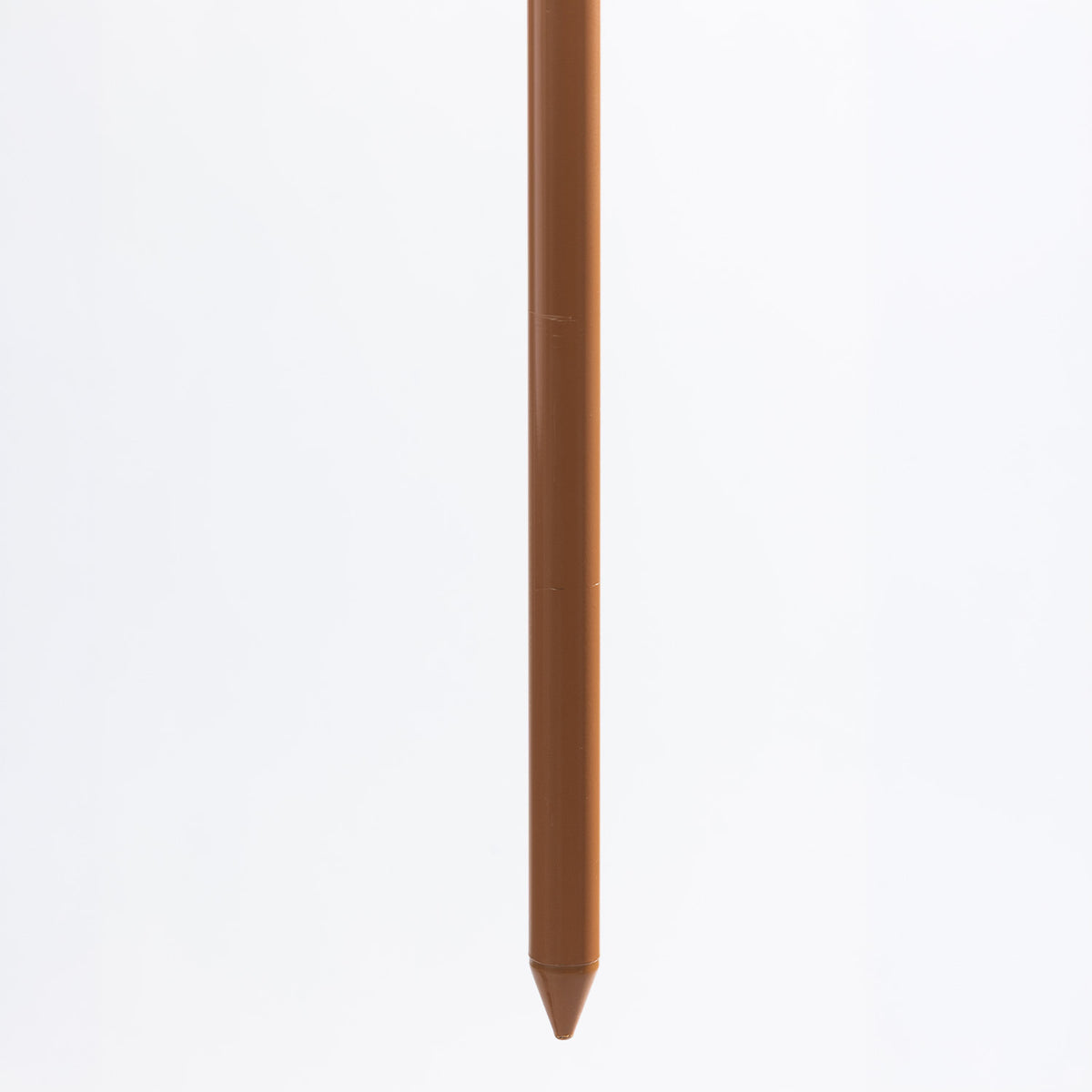 Close-up of the brown umbrella pole showing its pointed end.