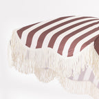 Close-up of the brown and white striped umbrella canopy showing the bold stripe design and cream fringe trim.