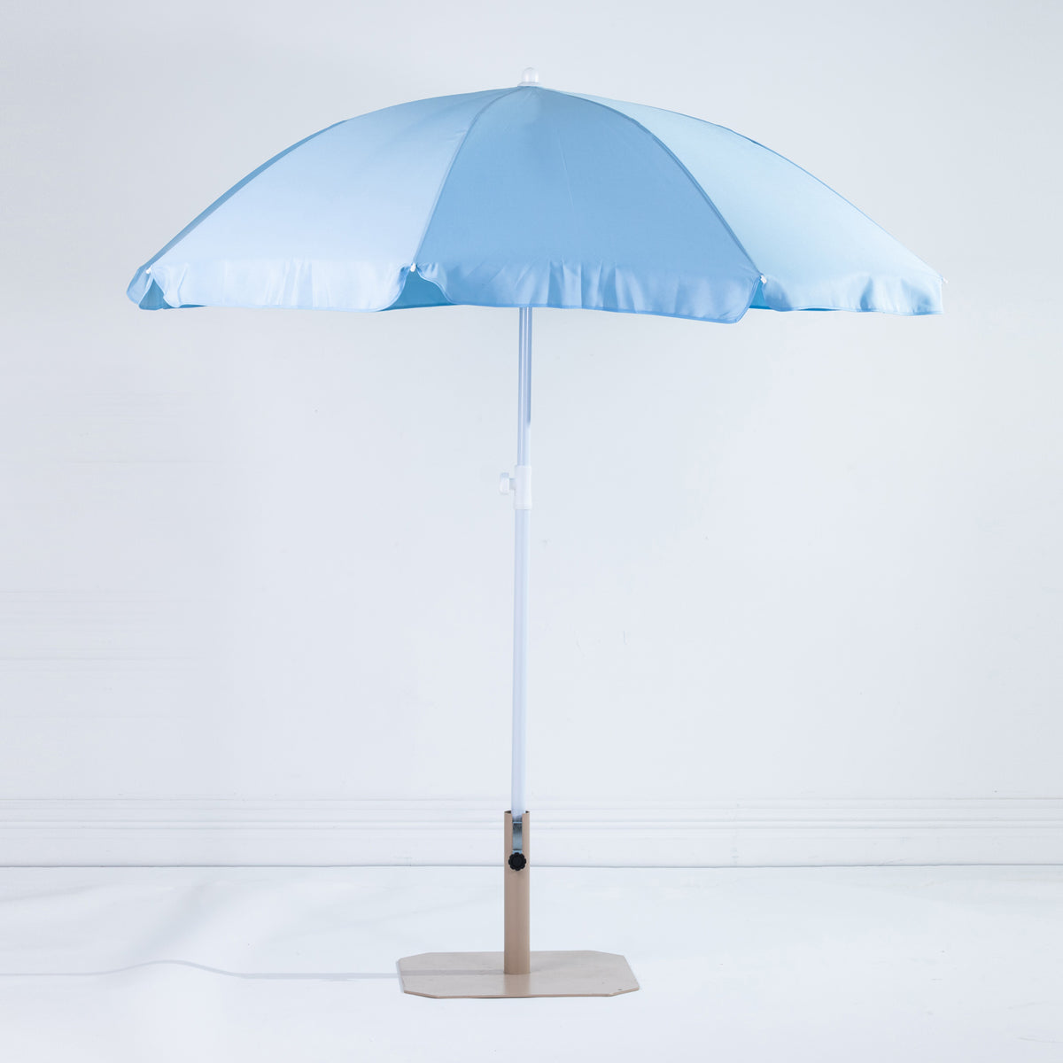 Seaside Supplies Blue Beach Umbrella featuring an open light blue canopy with a white adjustable pole and beige display stand against a white background.