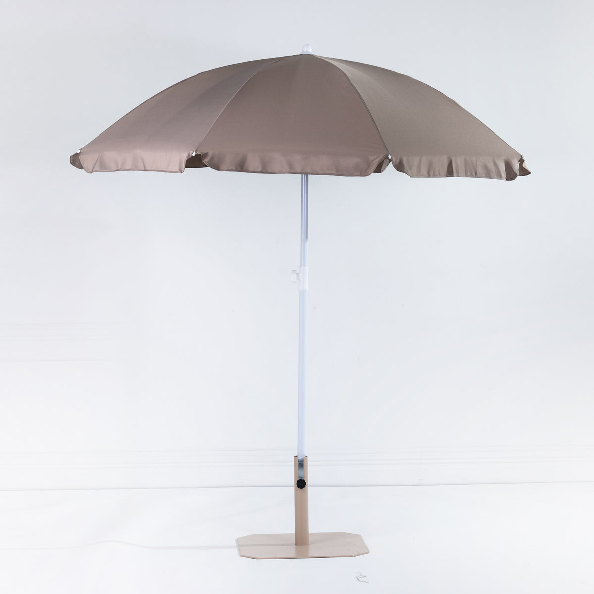 Seaside Supplies Chocolate Beach Umbrella featuring an open chocolate-brown canopy with a white adjustable pole and beige display stand against a white background.
