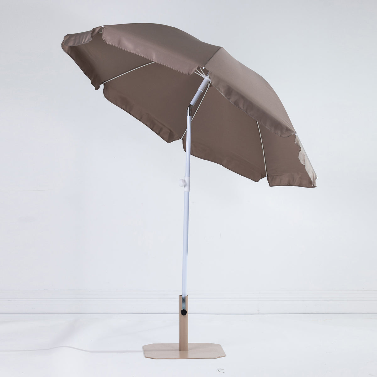 Seaside Supplies Chocolate Beach Umbrella shown open and tilted, revealing the chocolate-brown underside, white support ribs and adjustable pole against a white background.