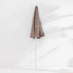 Seaside Supplies Chocolate Beach Umbrella featuring a folded taupe-brown canopy and white pole, displayed upright against a white background.