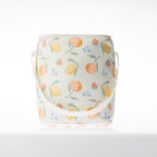 A fruit print cooler duffle bag with a white strap stands against a white background.