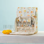 A picnic backpack with a built-in cutlery organizer, shown open with plates & plastic glasses.