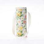 A floral print bottle bag with a white strap stands against a white background.