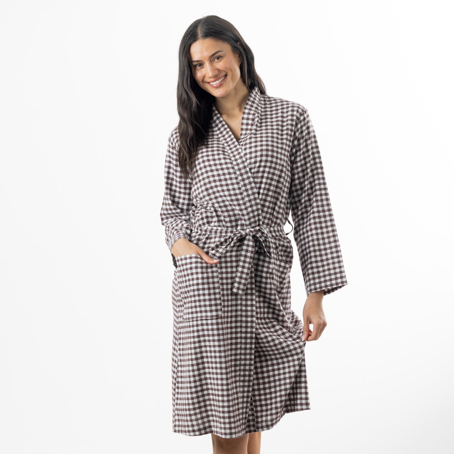 A woman modeling a brown and white gingham check robe with a tie belt, standing against a plain white studio background.