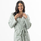 A woman models a soft sage green gingham robe featuring a wrap-front design, waist tie and roomy patch pockets.