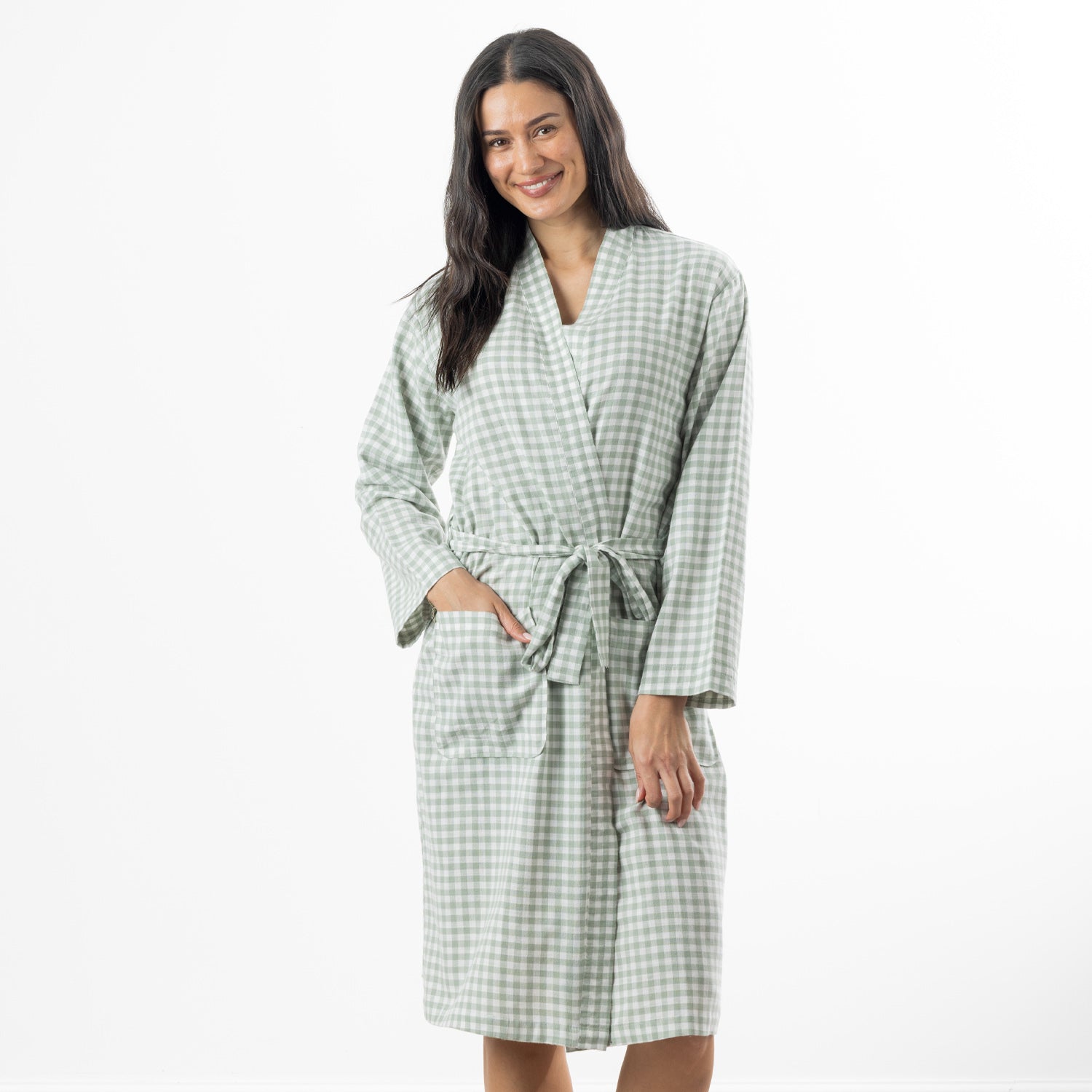 A woman models a soft sage green gingham robe featuring a wrap-front design, waist tie and roomy patch pockets.