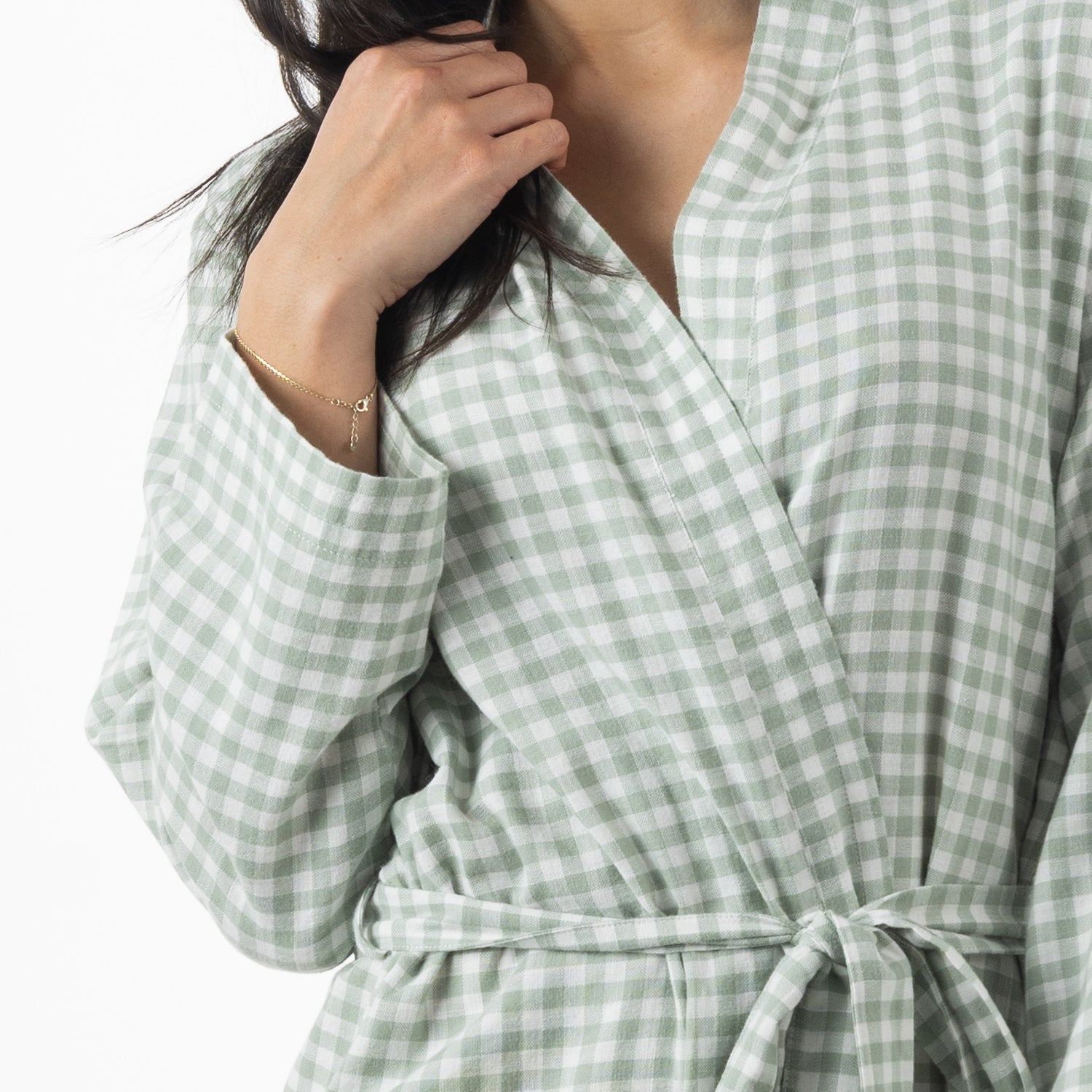 A close-up view highlights the soft sage green gingham fabric, wrap-front neckline and matching waist tie of the robe.
