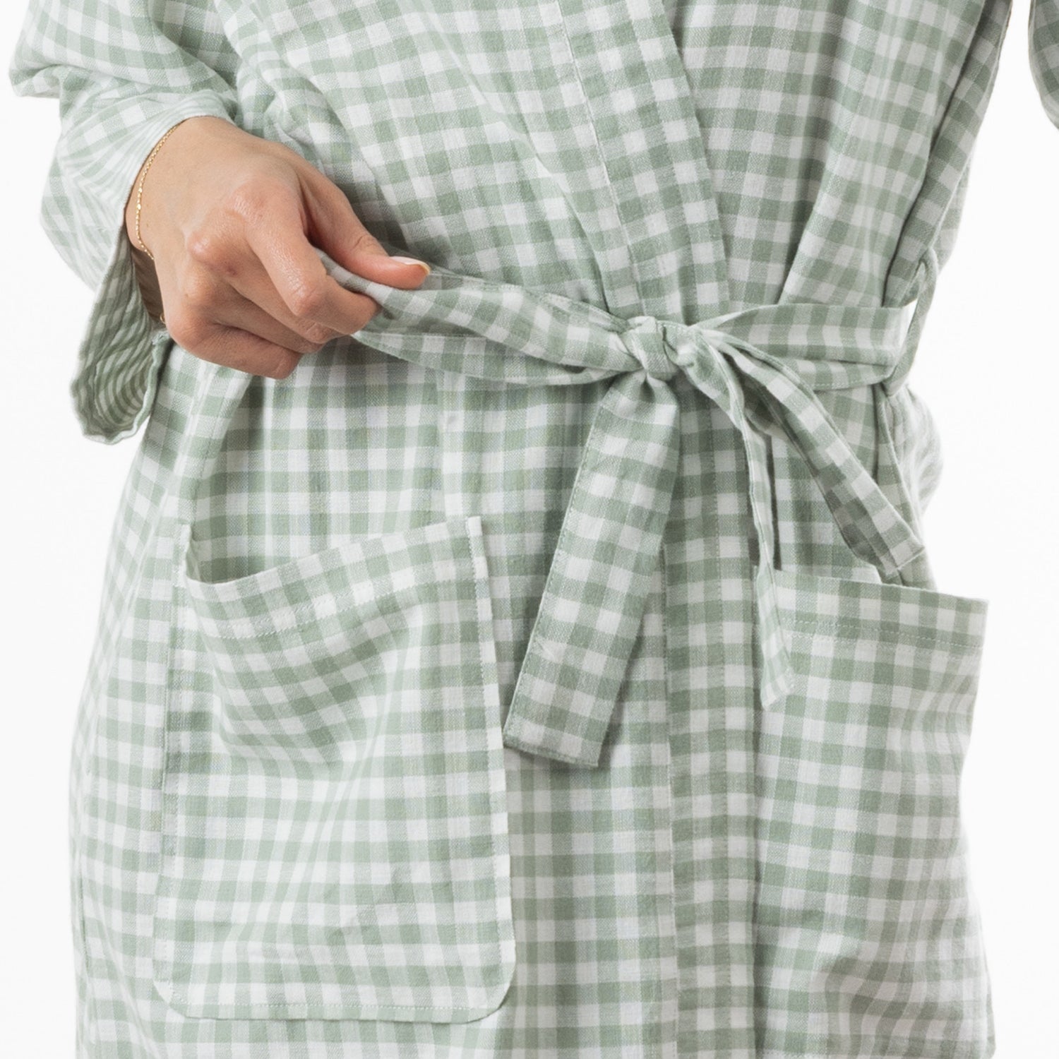 A close-up view highlights the sage green gingham robe’s matching waist tie and roomy front patch pockets.