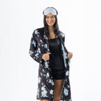 Eden Malibu Satin Printed Robe in Black worn open over matching sleepwear with a pale blue satin eye mask.