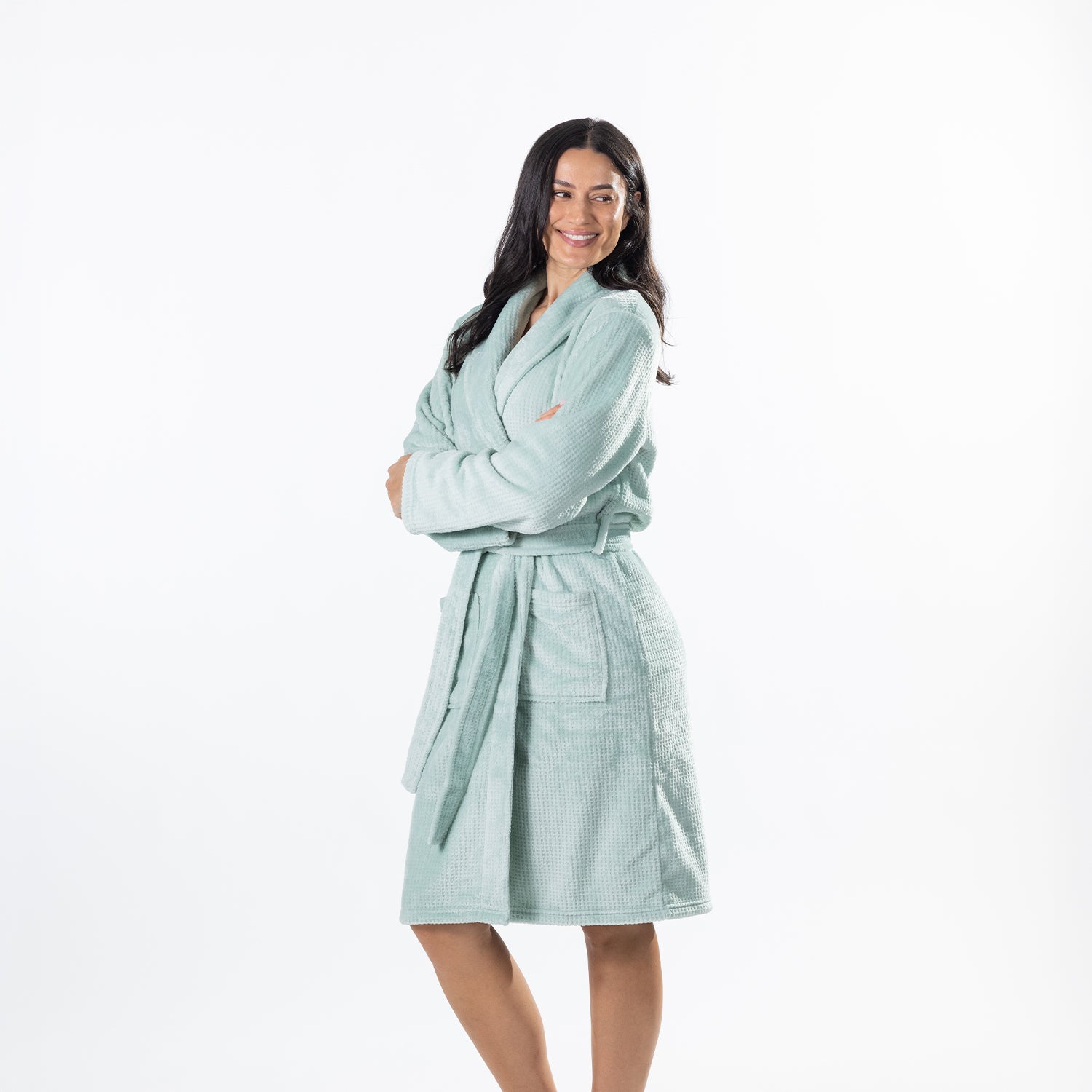 A woman modeling a light Sea Mist waffle-knit bathrobe against a plain white studio background.