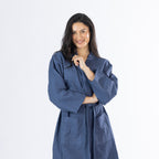 Model wearing an indigo Cove Dilys Waffle Bathrobe with a wrap-front design, long sleeves and waist tie belt.