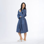 Model wearing an indigo Cove Dilys Waffle Bathrobe with textured fabric, long sleeves, front pockets and a waist tie belt.