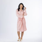 Full-length front view of a model wearing a pink textured stripe robe with a tie waist, long sleeves and front patch pockets, styled with slippers on a white background.