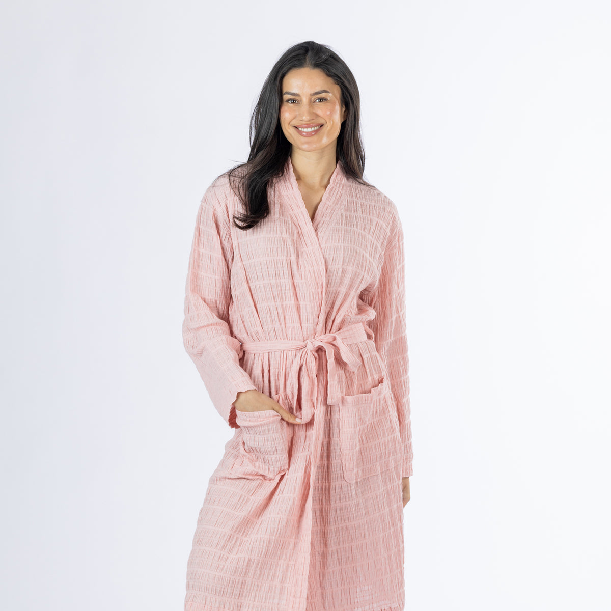 Mid-length front view of a model wearing the pink textured stripe robe, showing the wrap neckline, waist tie and front pocket detail.
