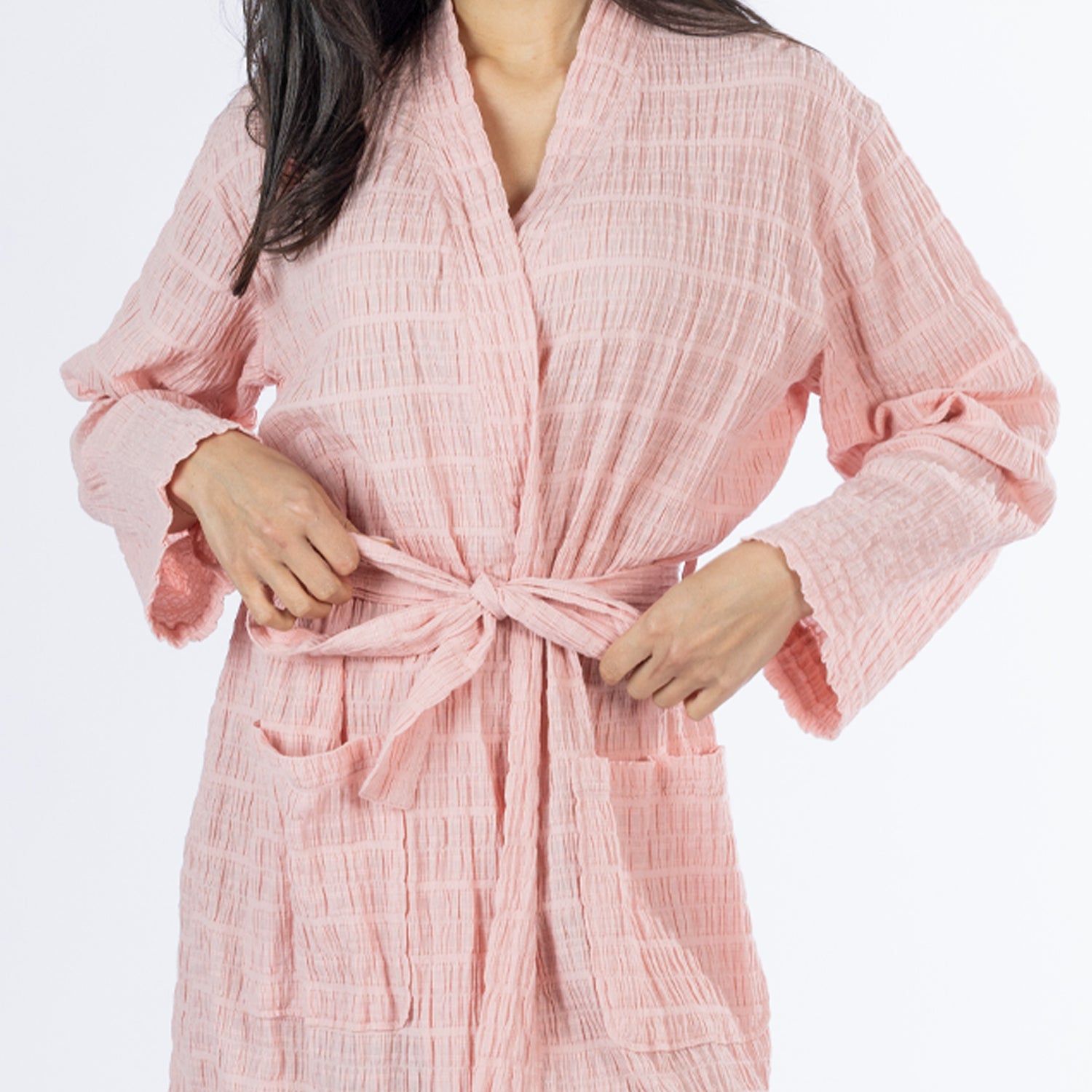 Close-up of the pink textured stripe robe showing the lightweight crinkled texture, wrap front, tie belt and patch pockets.