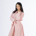 Mid-length angled view of a model wearing the pink textured stripe robe, showing the textured fabric, wrap neckline, waist tie and front pocket.