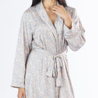 Close-up of the Amparo Cassie Satin Print Bathrobe in Pink, highlighting the detailed paisley pattern, shawl collar, white piping, long sleeves and matching waist tie.