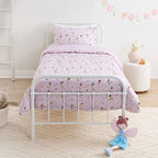 Kids fairy print duvet cover set styled on a white metal bed in a soft neutral bedroom.