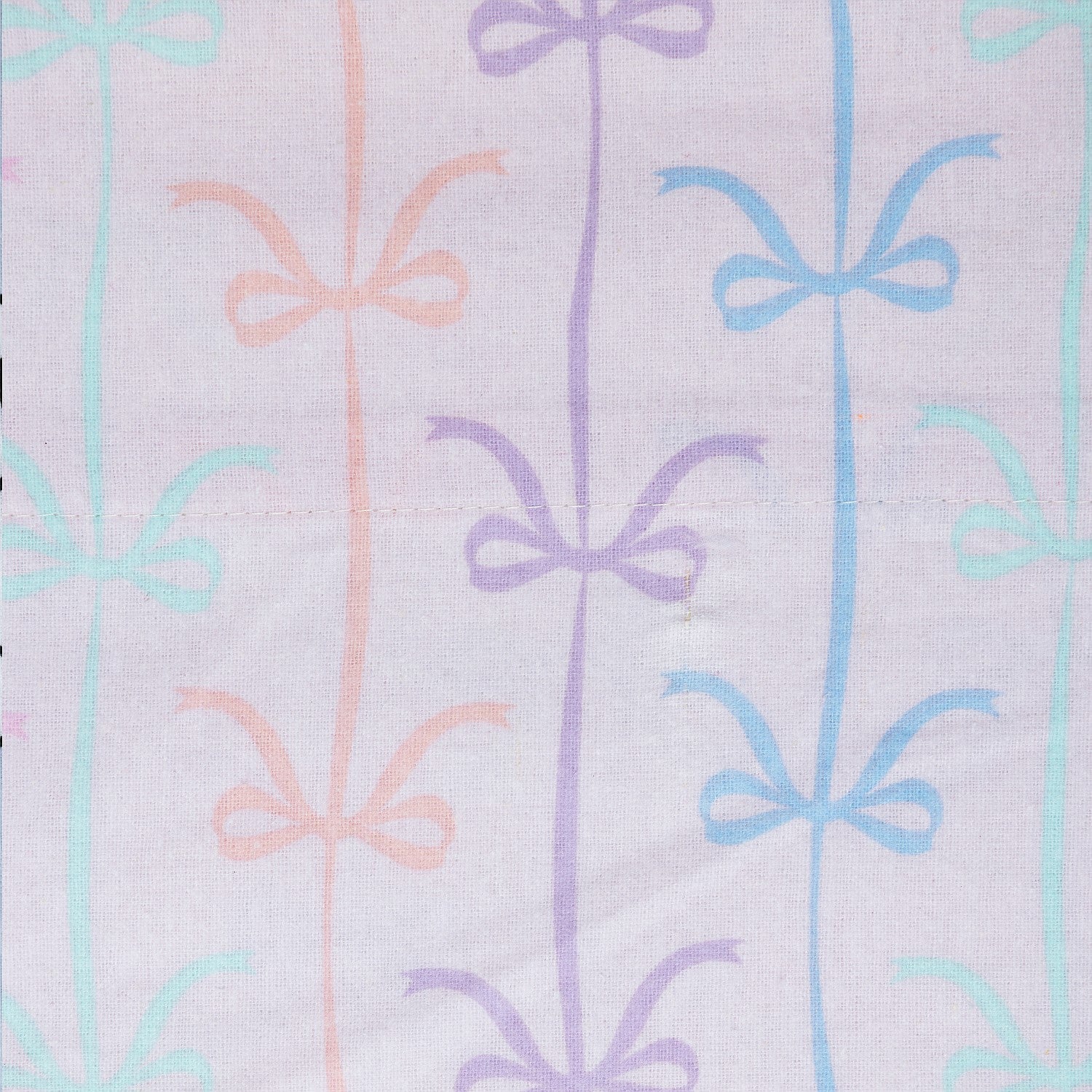 Pastel bow print fabric with soft pink and blue bows on a light background.