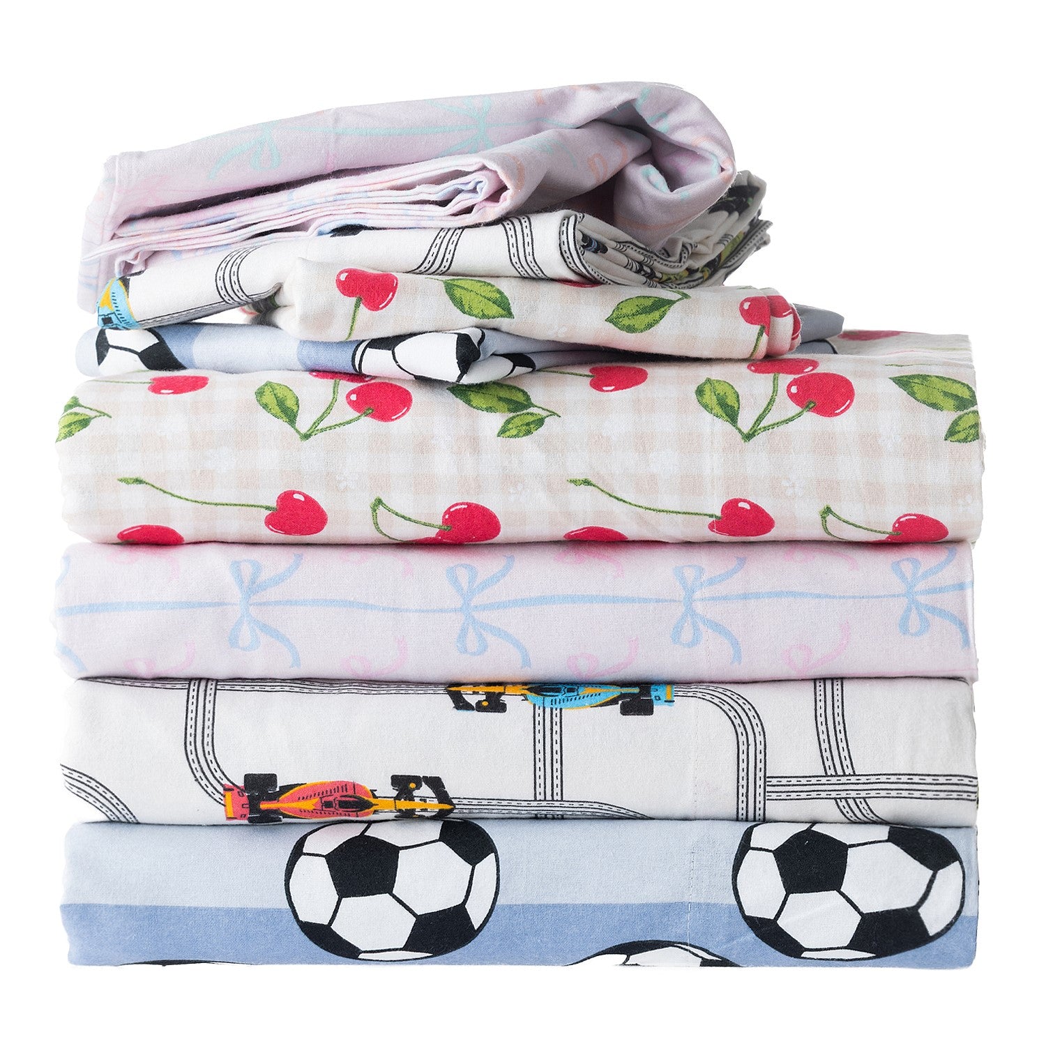 Folded kids duvet cover sets stacked together with cherry, soccer, cars, and bow designs.