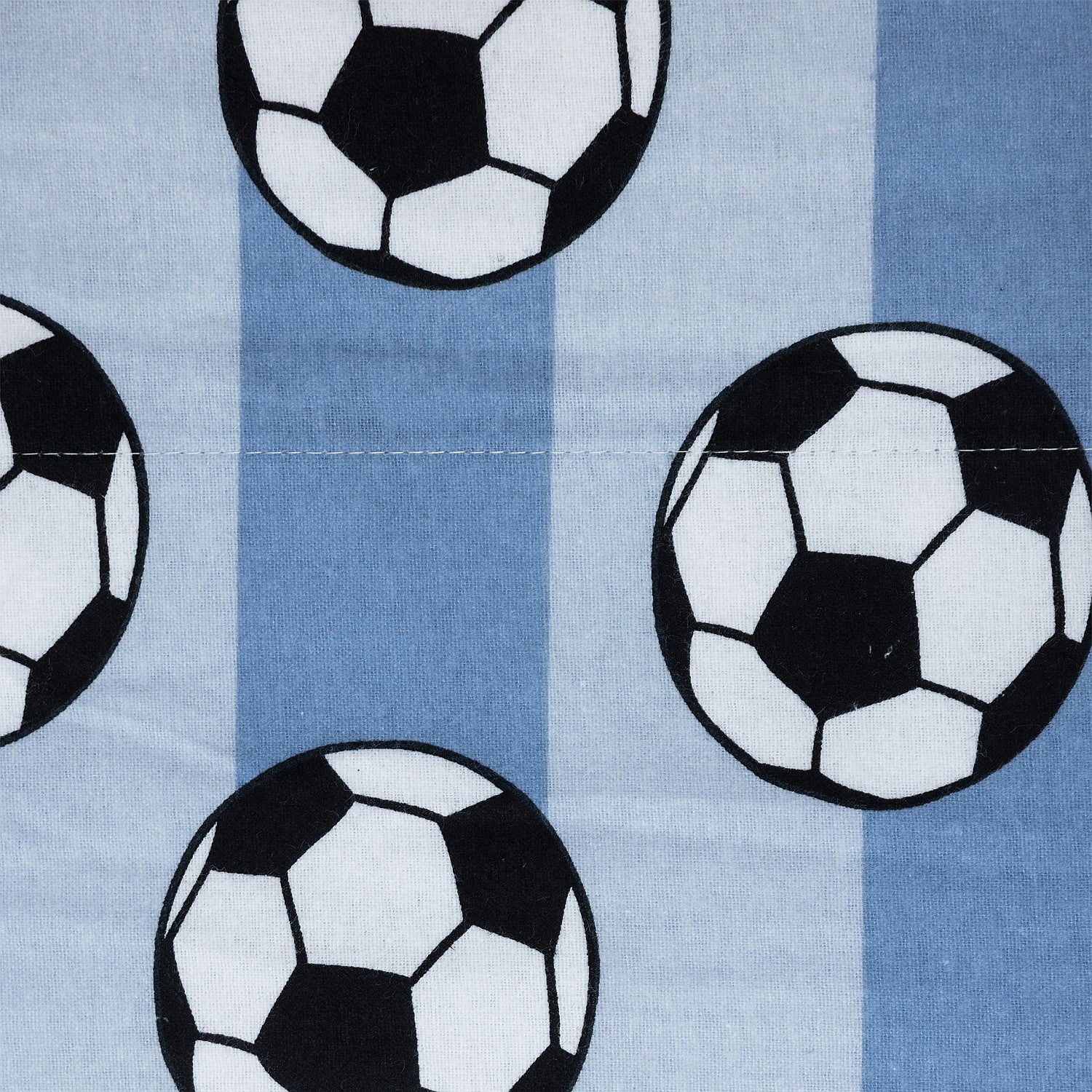 Soccer ball print fabric with black and white footballs on a blue background.