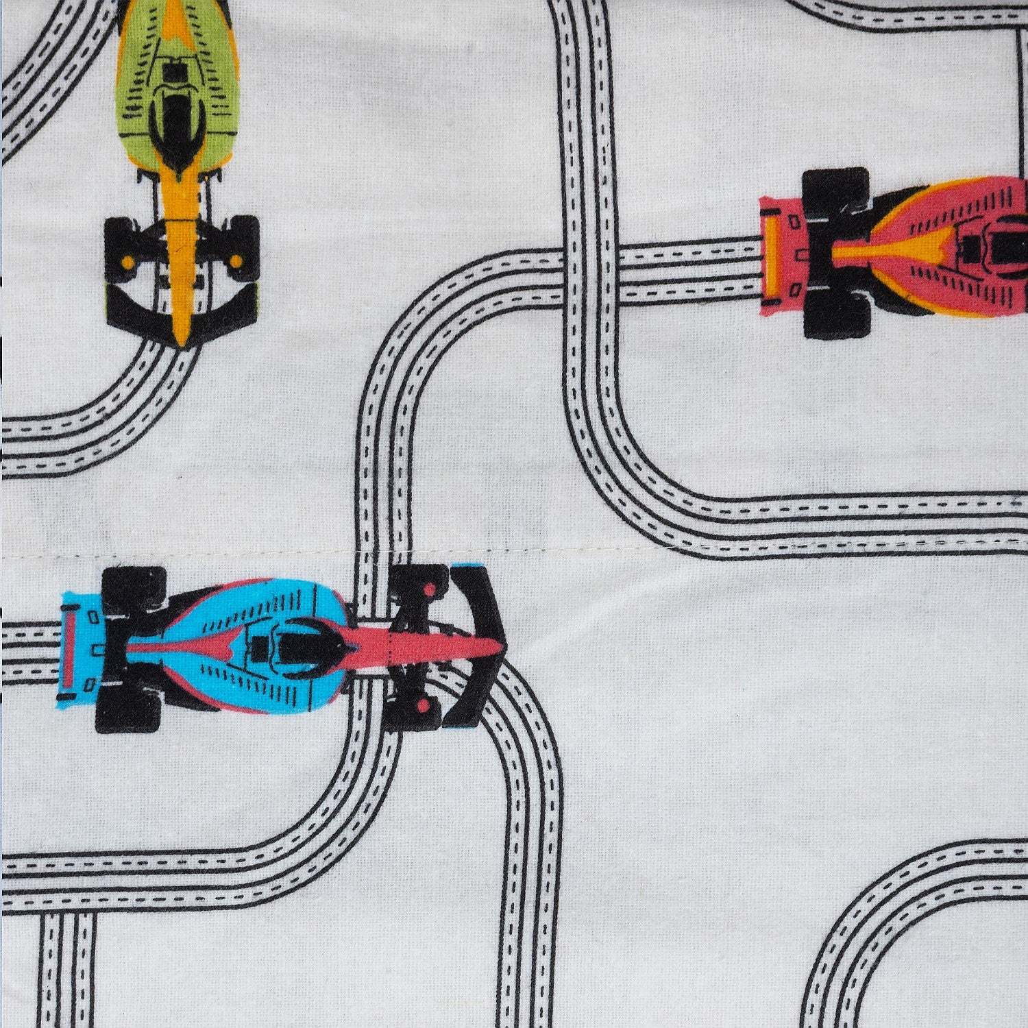 Kids race cars print fabric with colourful cars on a white background.