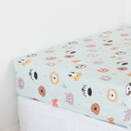 Kids animal print fitted sheet on a white mattress.