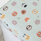 Kids animal print fitted sheet on a white mattress.