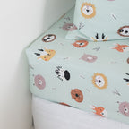 Kids animal print fitted sheet on a white mattress.