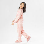 Child wearing pink striped flannelette pyjamas on a white background.