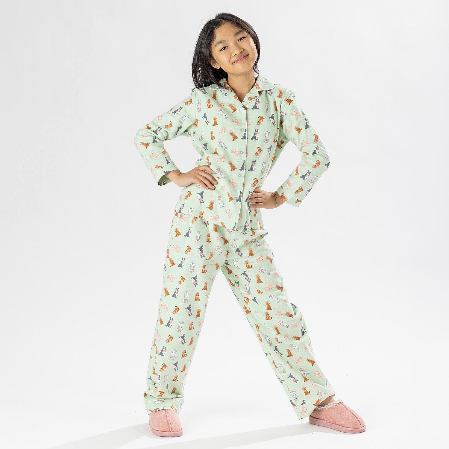 Child wearing bb&b Sleep Kids Dog flannelette pyjama set with a playful all-over print.