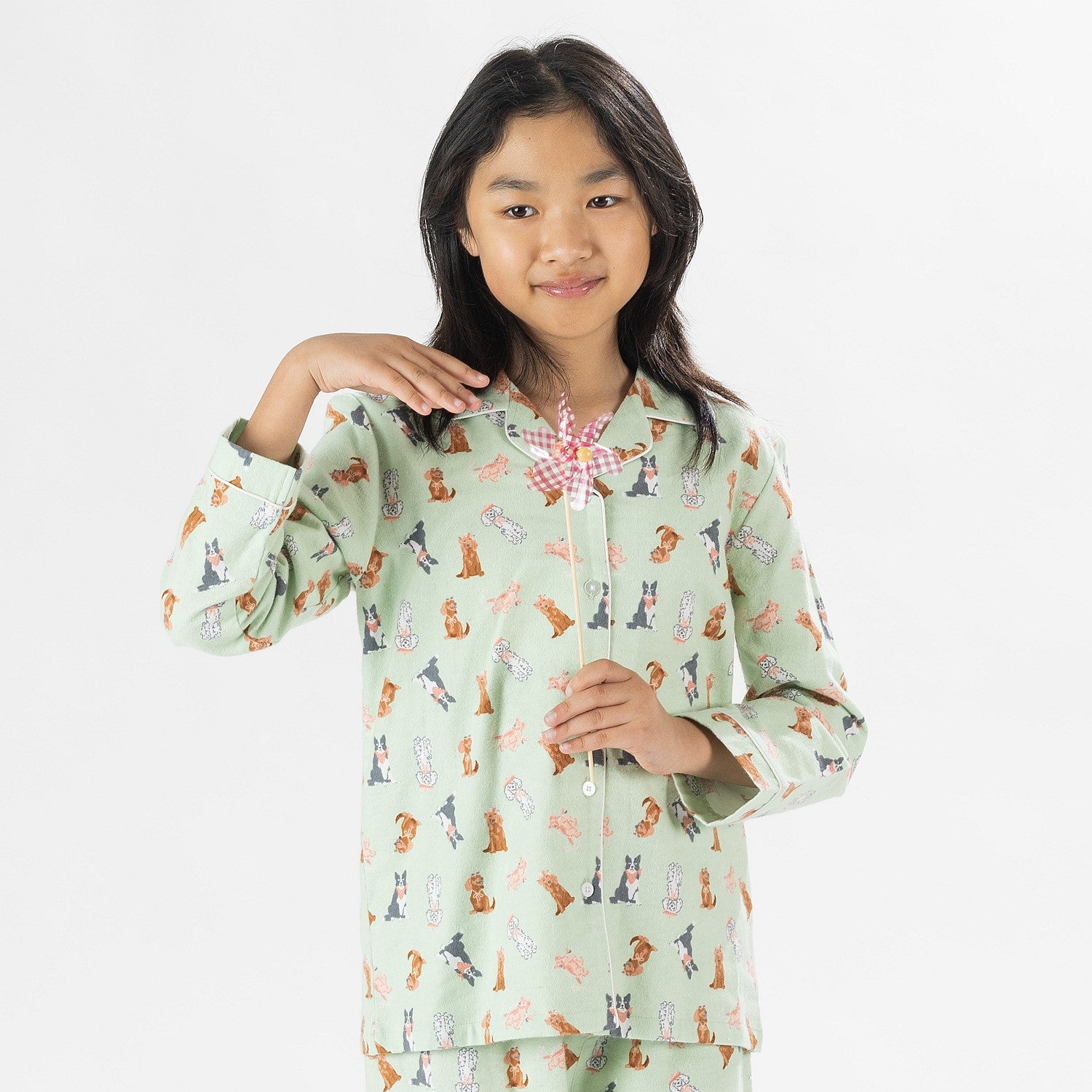 Child wearing bb&b Sleep Kids Dog flannelette pyjama set with a playful all-over print.