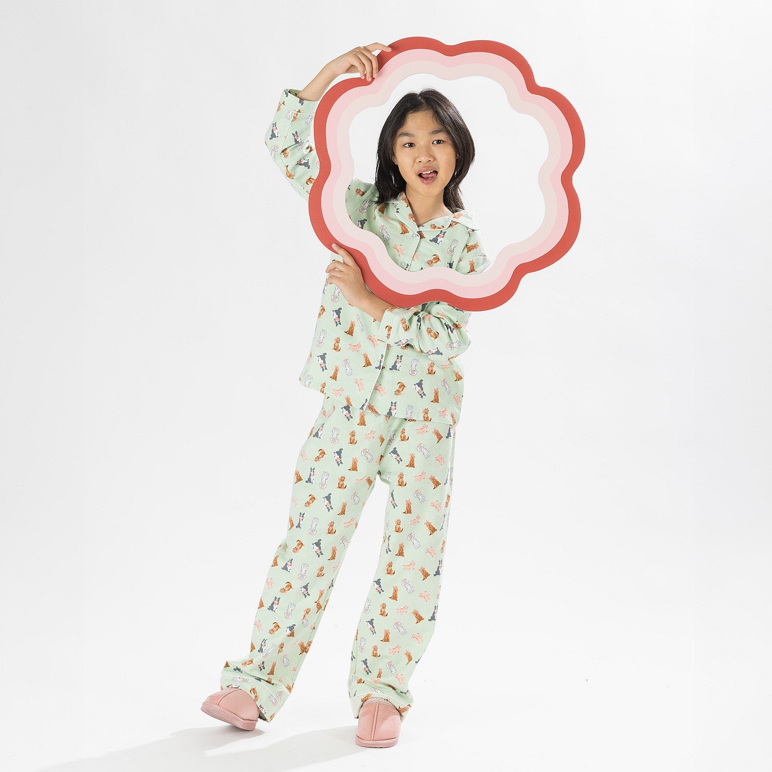 Child wearing bb&b Sleep Kids Dog flannelette pyjama set with a playful all-over print.