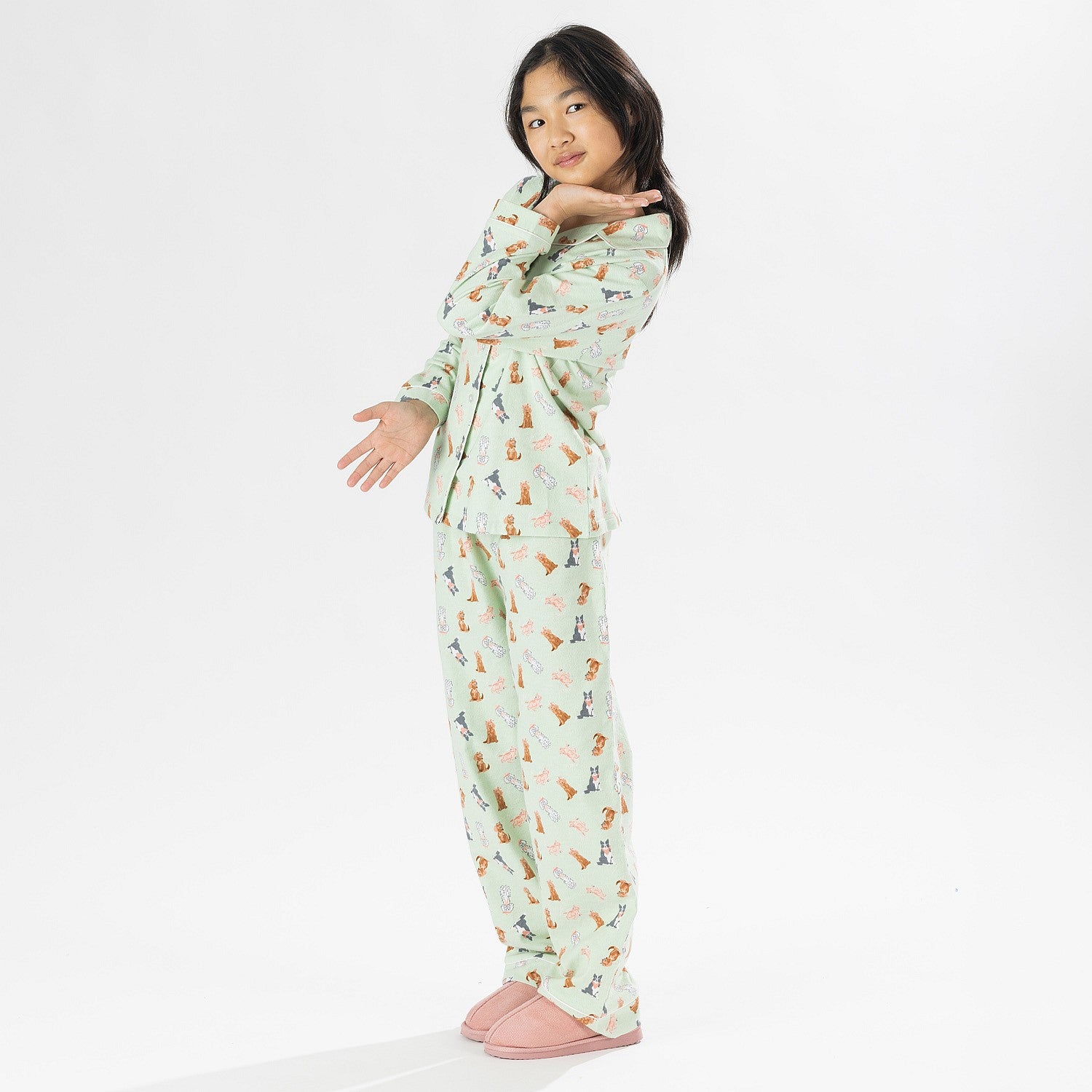 Child wearing bb&b Sleep Kids Dog flannelette pyjama set with a playful all-over print.