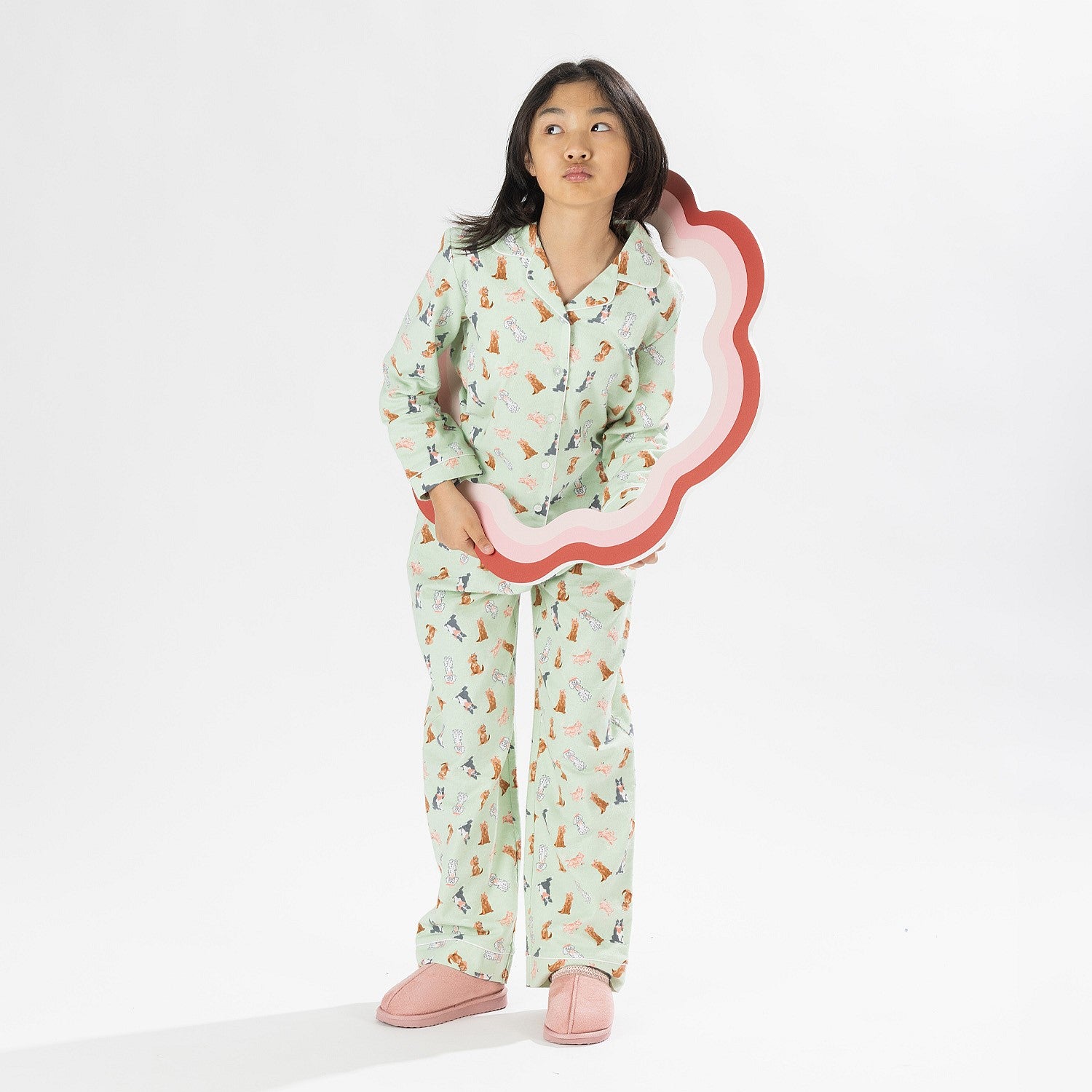 Child wearing bb&b Sleep Kids Dog flannelette pyjama set with a playful all-over print.