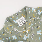 green soccer print pyjamas up close with the tag and caution label shwoing