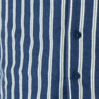 Child wearing blue striped flannelette pyjamas with blue buttons