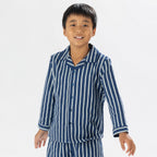 Close up of child wearing blue striped flannelette pyjamas 