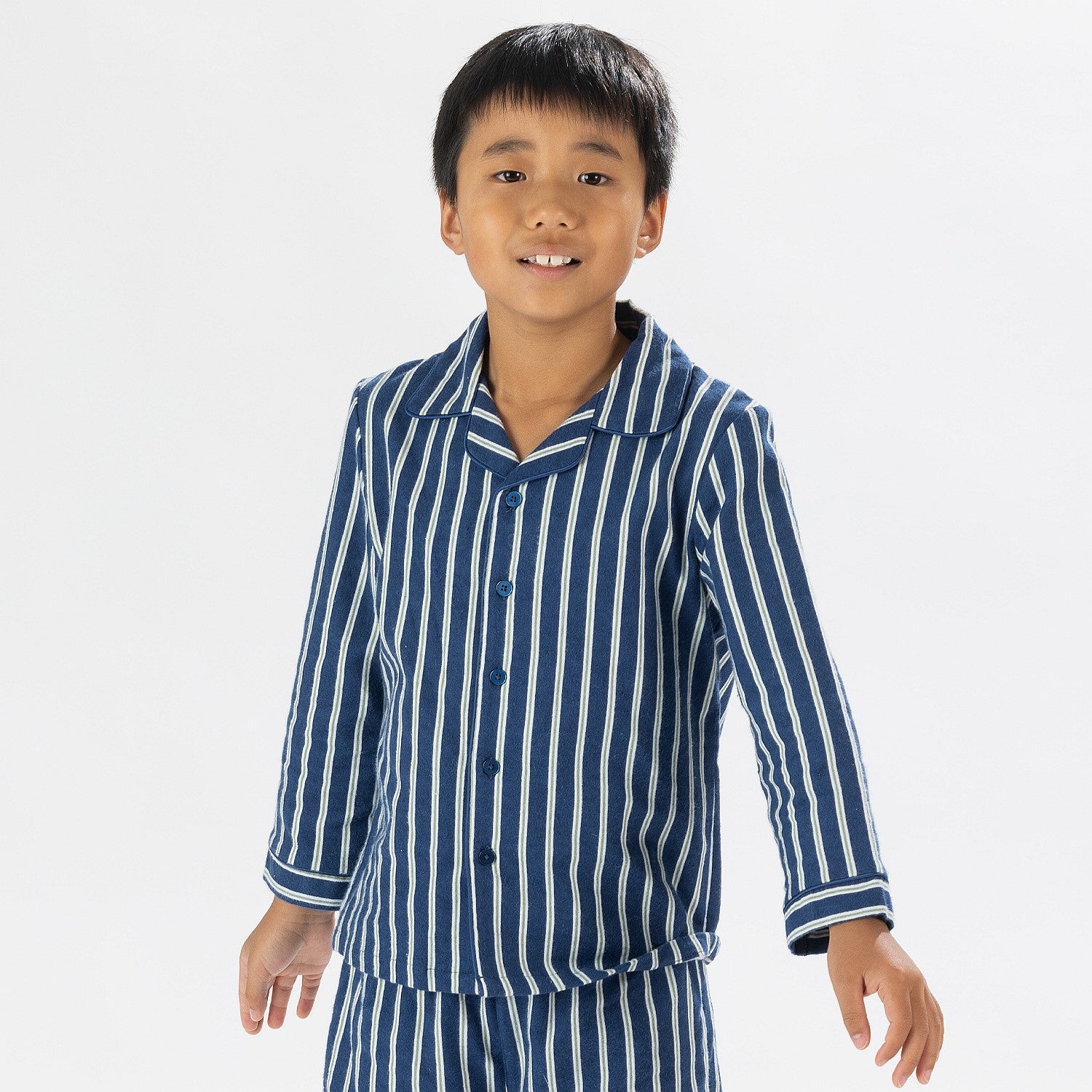 Close up of child wearing blue striped flannelette pyjamas 