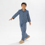 Child wearing blue striped flannelette pyjamas